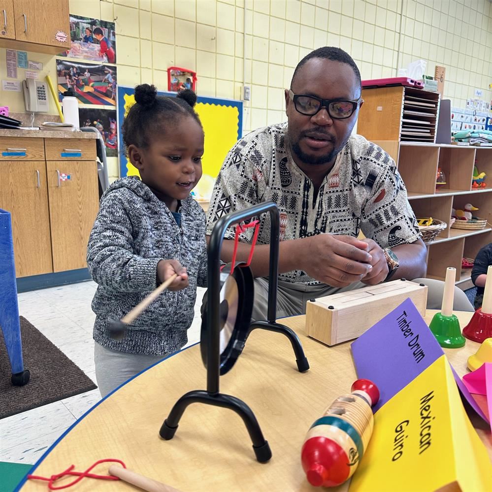  adult with child at table